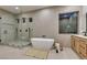 Serene bathroom with a freestanding tub, glass shower, natural light and sleek modern finishes at 6009 Silvalde Ln, Las Vegas, NV 89135