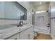 Bathroom features quartz countertop, sleek modern hardware, and bathtub with shower at 6009 Silvalde Ln, Las Vegas, NV 89135