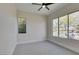 Bright bedroom with a large window bringing in natural light and a ceiling fan at 6009 Silvalde Ln, Las Vegas, NV 89135