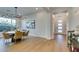 Open dining room with a modern chandelier and large windows providing natural light at 6009 Silvalde Ln, Las Vegas, NV 89135