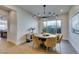 Chic dining room with modern chandelier, and bright natural light from a large window at 6009 Silvalde Ln, Las Vegas, NV 89135