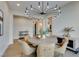 Bright dining room featuring a modern light fixture and seating for six around a round wooden table at 6009 Silvalde Ln, Las Vegas, NV 89135