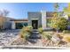 Stylish modern home with desert landscaping, a brick driveway, and an attached two-car garage at 6009 Silvalde Ln, Las Vegas, NV 89135