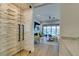 Hallway showcases a wine rack with glass doors, leading into a living area with fireplace and sliding doors at 6009 Silvalde Ln, Las Vegas, NV 89135