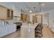 Contemporary kitchen featuring a large center island with bar seating and built-in stainless steel appliances at 6009 Silvalde Ln, Las Vegas, NV 89135