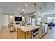 Open concept kitchen and living area with a view of the backyard and stainless appliances at 6009 Silvalde Ln, Las Vegas, NV 89135