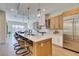 Spacious kitchen featuring an eat-in island, a stainless steel refrigerator, and an open floor plan at 6009 Silvalde Ln, Las Vegas, NV 89135