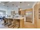 Open kitchen concept featuring stainless steel appliances, large island, and decorative pendant lighting at 6009 Silvalde Ln, Las Vegas, NV 89135