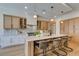 Modern kitchen with island seating, pendant lighting, stainless appliances and stylish cabinetry at 6009 Silvalde Ln, Las Vegas, NV 89135