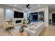 Bright living room featuring a stone fireplace and sliding doors to the outdoor living area at 6009 Silvalde Ln, Las Vegas, NV 89135