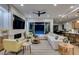 Bright living room with a stone fireplace, ceiling fan, and sliding doors to the backyard pool at 6009 Silvalde Ln, Las Vegas, NV 89135