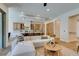 Spacious living room flows into kitchen with stainless steel appliances and island seating, perfect for entertaining at 6009 Silvalde Ln, Las Vegas, NV 89135