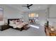 This main bedroom features a large bed, ceiling fan, and a sitting area at 6009 Silvalde Ln, Las Vegas, NV 89135