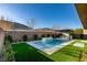 Backyard pool featuring a built-in water feature and an outdoor kitchen at 6009 Silvalde Ln, Las Vegas, NV 89135