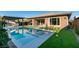 Backyard pool featuring a built-in water feature and an outdoor kitchen with bar seating at 6009 Silvalde Ln, Las Vegas, NV 89135