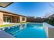 Sparkling backyard pool featuring a tanning ledge and lush landscaping for ultimate relaxation at 6009 Silvalde Ln, Las Vegas, NV 89135