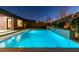 Stunning backyard pool with a modern water feature and meticulously landscaped surroundings at 6009 Silvalde Ln, Las Vegas, NV 89135