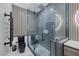 Modern bathroom featuring a glass shower, black fixtures, and striking vertical striped wall accents at 6021 Vista Clara St, Las Vegas, NV 89148