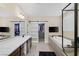 Bright bathroom with a double vanity, soaking tub, shower, and closet with sliding barn doors at 6021 Vista Clara St, Las Vegas, NV 89148