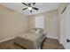 Cozy bedroom with neutral walls, wood-look flooring, ceiling fan, and a comfortable bed with decorative pillows at 6021 Vista Clara St, Las Vegas, NV 89148