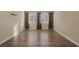 Bedroom featuring hardwood floors, neutral walls, and two windows with blinds at 6021 Vista Clara St, Las Vegas, NV 89148