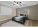 A nicely staged bedroom featuring a ceiling fan, hardwood flooring, and modern accent wall at 6021 Vista Clara St, Las Vegas, NV 89148