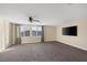 Bright bonus room with plush carpeting, neutral walls, a ceiling fan, and a flat screen television at 6021 Vista Clara St, Las Vegas, NV 89148