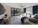 Bright living room with hardwood floors, ceiling fan and folding doors to backyard pool at 6021 Vista Clara St, Las Vegas, NV 89148