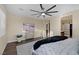 Comfortable main bedroom featuring wood floors, a ceiling fan, and a dresser with a TV at 6021 Vista Clara St, Las Vegas, NV 89148