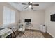 Bright home office with a modern glass desk, plush chair and wood flooring at 6021 Vista Clara St, Las Vegas, NV 89148