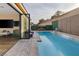 Relaxing pool area with lounge seating and lush landscaping visible through sliding glass doors from the interior at 6021 Vista Clara St, Las Vegas, NV 89148