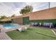 Enjoy this backyard view with pool, lounge chairs and artificial grass for easy care at 6021 Vista Clara St, Las Vegas, NV 89148