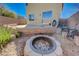 Backyard featuring a built-in fire pit and patio area at 608 Breezy Sage Ct, Henderson, NV 89015