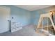 This bedroom offers soft blue walls and carpet flooring and features a play structure and storage at 608 Breezy Sage Ct, Henderson, NV 89015