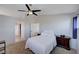 A bright, airy bedroom features a ceiling fan, carpet, and soft lighting from a ceiling fan at 608 Breezy Sage Ct, Henderson, NV 89015