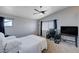 Bedroom with a large window, ceiling fan, and neutral-colored walls and carpet at 608 Breezy Sage Ct, Henderson, NV 89015