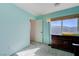 This bedroom has soft blue walls and carpet flooring and features a large window with blinds at 608 Breezy Sage Ct, Henderson, NV 89015