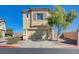 Two-story home with a neutral color scheme, two-car garage, and simple landscaping at 608 Breezy Sage Ct, Henderson, NV 89015