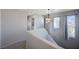 Hallway bathed in natural light from nearby windows offering serene views, enhancing the home's airy atmosphere at 608 Breezy Sage Ct, Henderson, NV 89015