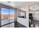 A naturally lit living room features hardwood floors and sliding glass doors leading to an outdoor patio area at 608 Breezy Sage Ct, Henderson, NV 89015