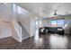 Spacious living room features hardwood floors, a ceiling fan, a gray sectional sofa, and plenty of natural light at 608 Breezy Sage Ct, Henderson, NV 89015