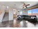 Living room showcases wood floors, modern sectional, and views to the backyard at 608 Breezy Sage Ct, Henderson, NV 89015