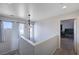 Bright, carpeted staircase landing with an elegant light fixture and plenty of natural light at 608 Breezy Sage Ct, Henderson, NV 89015