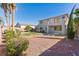 A spacious backyard offers a lawn, gravel, a patio, and desert landscaping at 6337 Black Mane Way, North Las Vegas, NV 89081