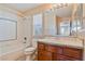 Bathroom featuring a vanity, toilet, shower, and a window with blinds for natural light at 6337 Black Mane Way, North Las Vegas, NV 89081