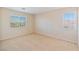 This bedroom features neutral walls, carpet and two windows, offering a bright and comfortable space at 6337 Black Mane Way, North Las Vegas, NV 89081