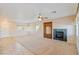 Bright living room featuring a fireplace, ceiling fan, and tile/carpet flooring at 6337 Black Mane Way, North Las Vegas, NV 89081