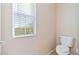 Powder room with a toilet and a window with outside views at 6337 Black Mane Way, North Las Vegas, NV 89081