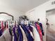 Walk-in closet filled with clothes, shoes, and accessories and an open door at 6630 Bubbling Brook Dr # C, Las Vegas, NV 89107