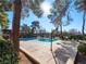 Beautiful community pool surrounded by lush greenery and mature trees at 6630 Bubbling Brook Dr # C, Las Vegas, NV 89107